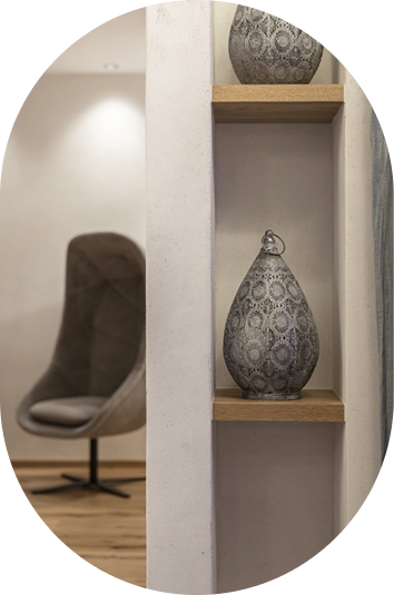 Graue gemusterte Vase auf einem Holzregal, perfekt für eine moderne Bildergalerie.